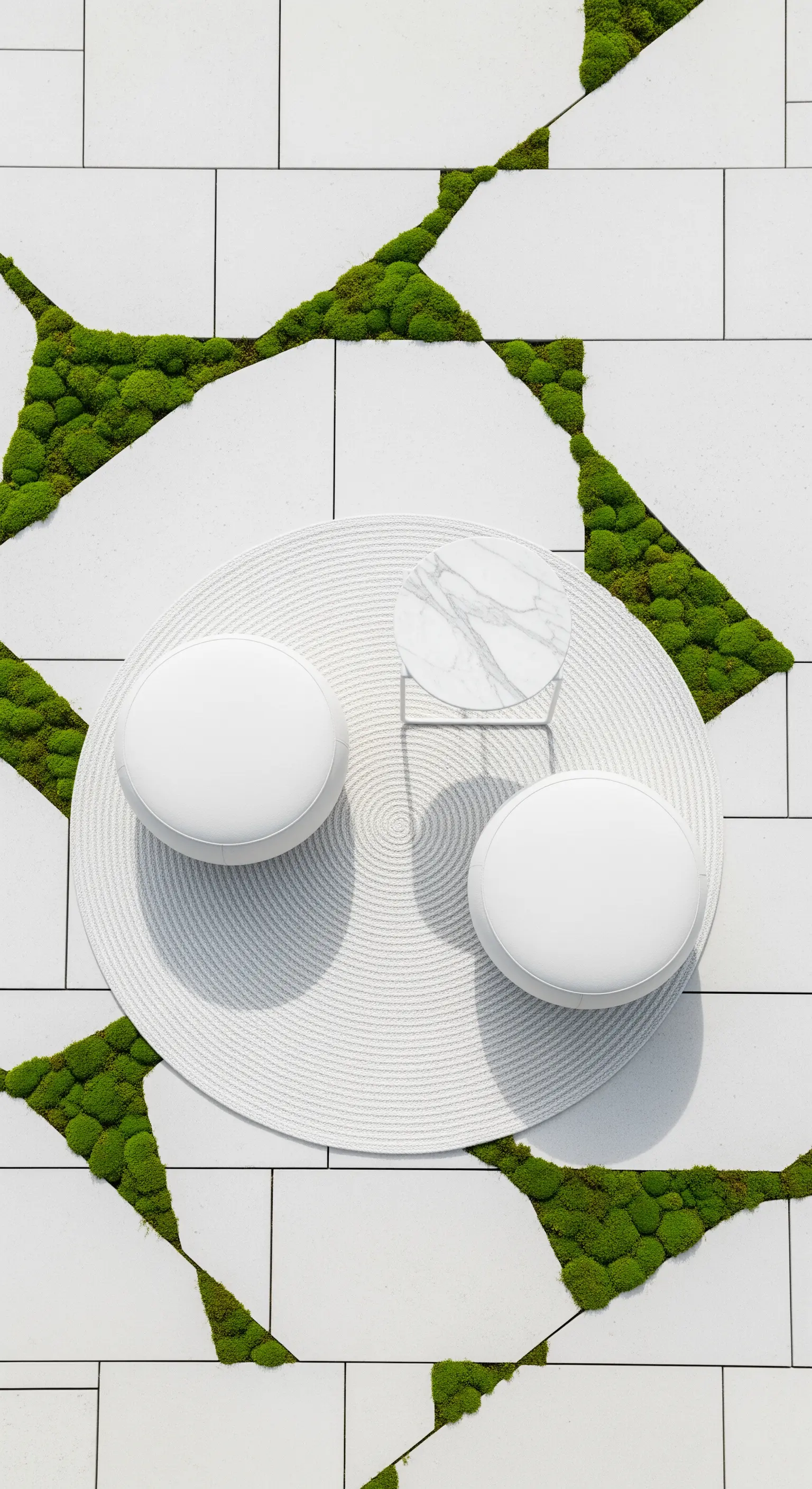 Outdoor-Sitzgruppe auf runder Matte mit Moos zwischen Fliesen