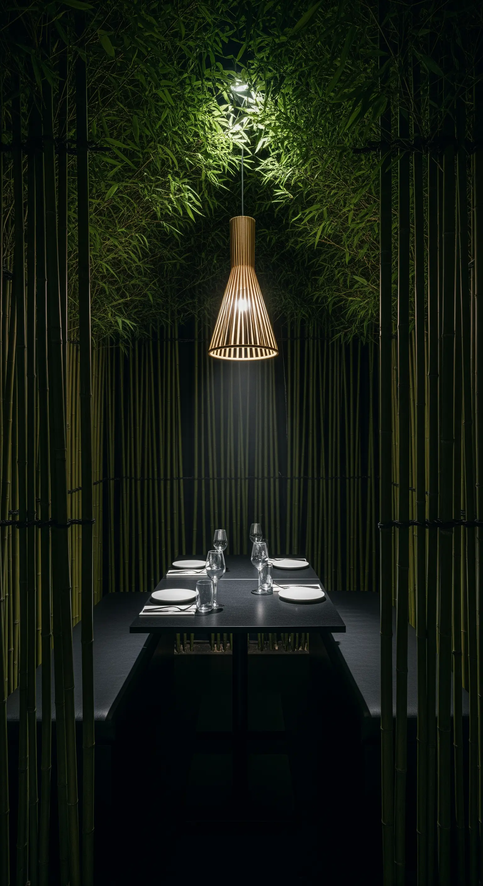 Intimer Essbereich, umgeben von Bambus mit einer Holz-Pendelleuchte